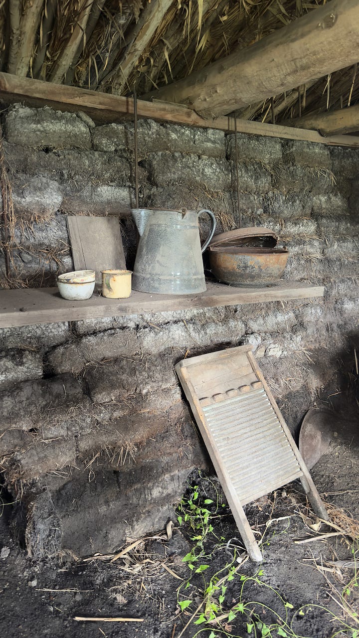 The inside of a wealthy family’s sod house. | A small girl looking at a crib full of handmade dolls. | The exterior of a falling-apart sod house. | The inside of a poor family’s house with a rusting washboard and a tin pitcher.