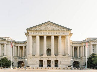 Exterior front face of the Andrew W. Mellon Auditorium when viewed from across the street on a sunny morning. Exterior front face of the Andrew W. Mellon Auditorium when viewed from across the street on a sunny morning.