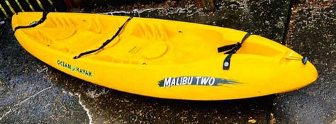 Red kayak in river, orange kayak tip, two kayers, yellow Malibu Two kayak