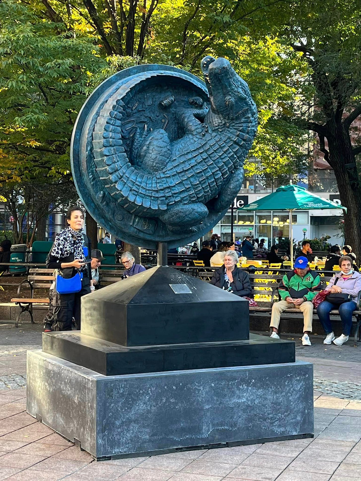 May be an image of 4 people and monument