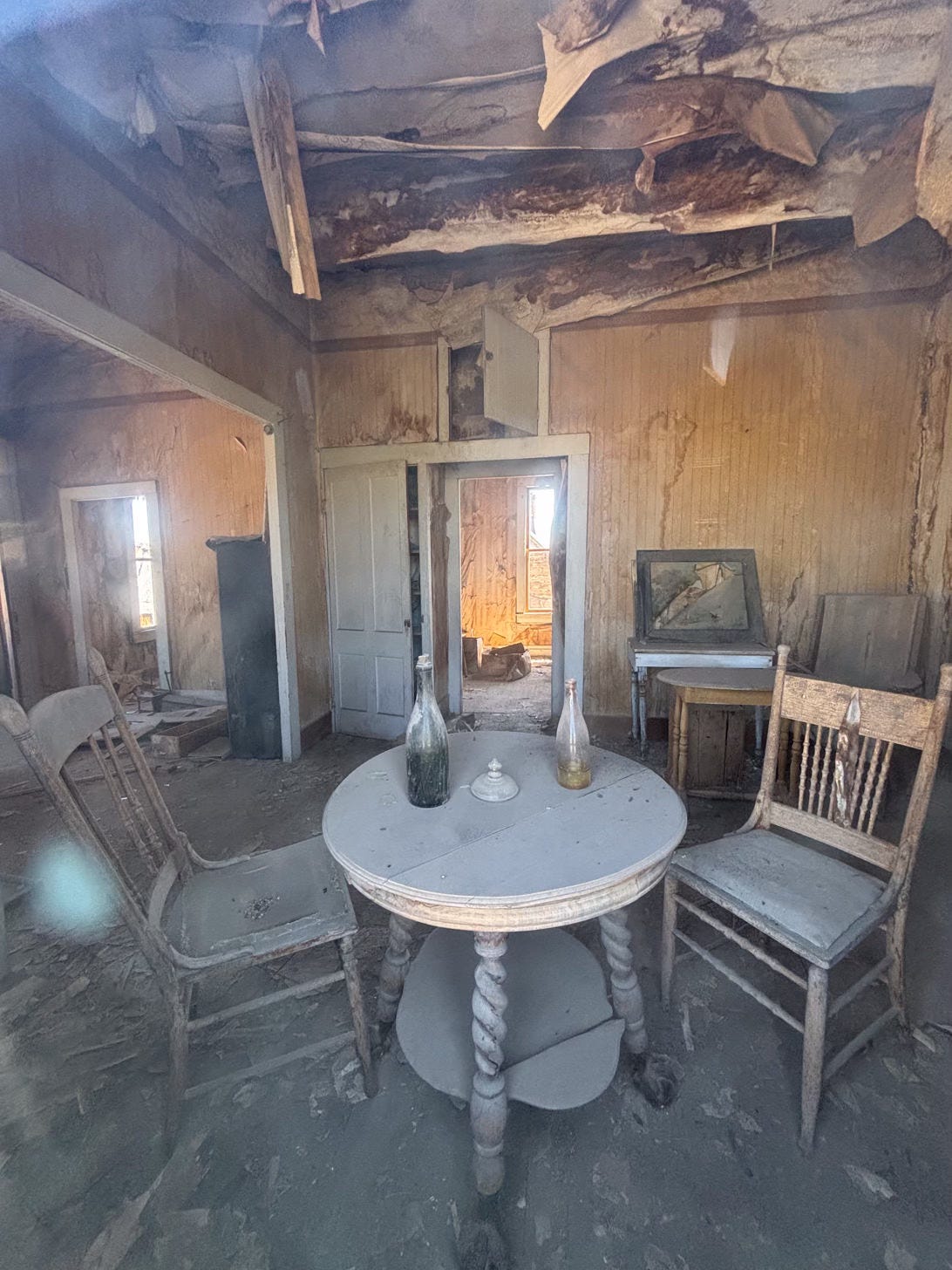 interior room in a decaying state with table and chairs