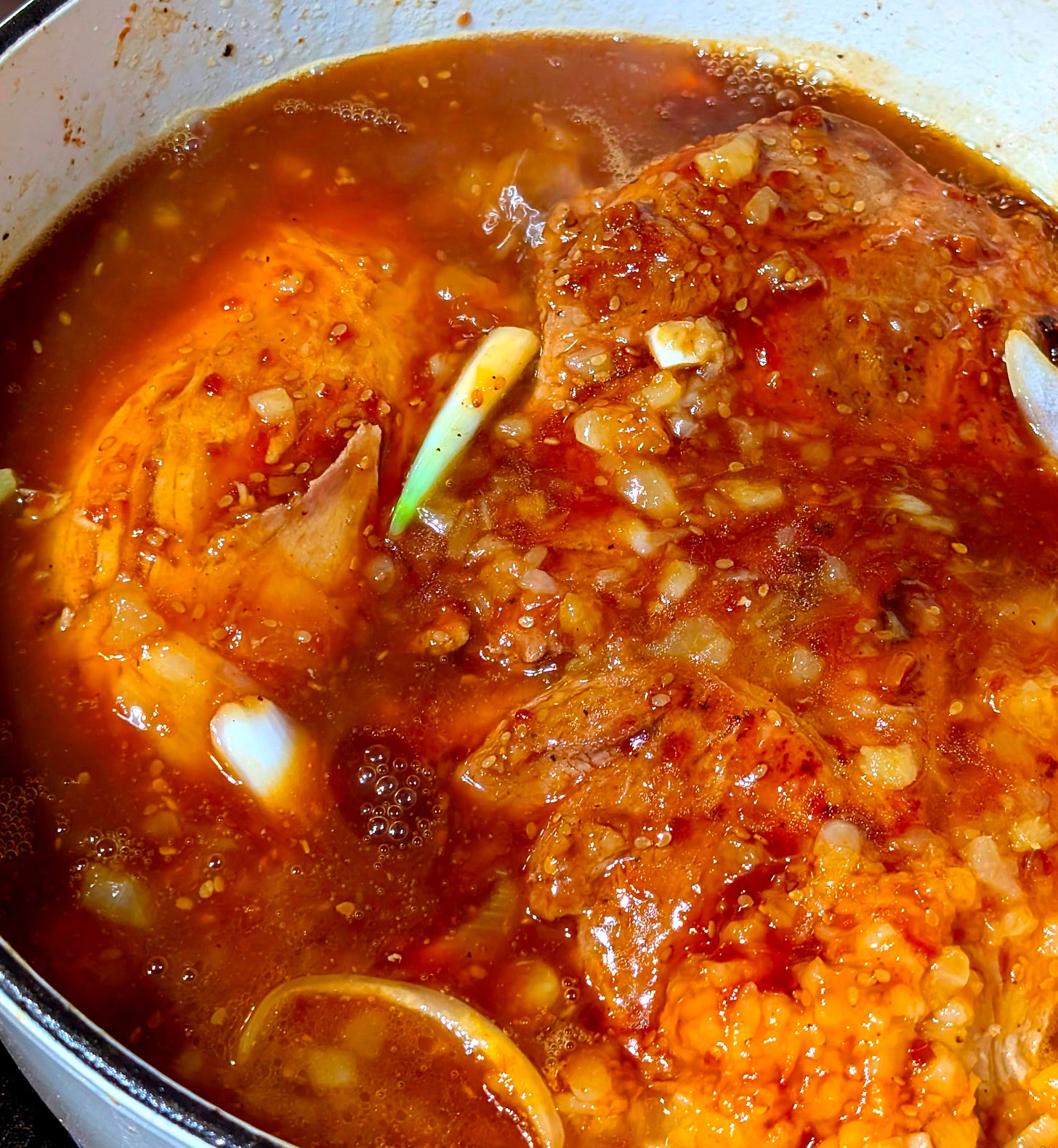 A glamour close-up of pork in a sea of pineapple and teriyaki sauce. A glamour close-up of pork in a sea of pineapple and teriyaki sauce.