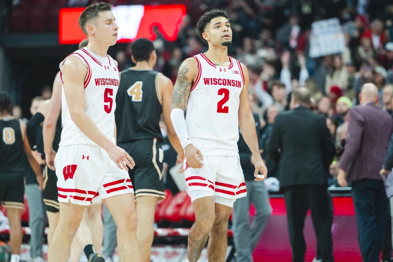 Nick Boyd looking up and to the side while Janicki's eyes are closed. the two walk side by side.