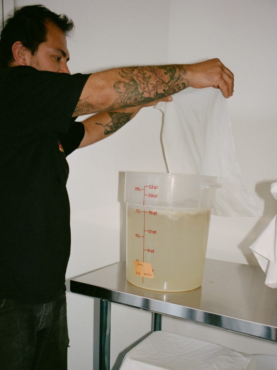 Balo shows off a kombucha scoby in his commissary kitchen