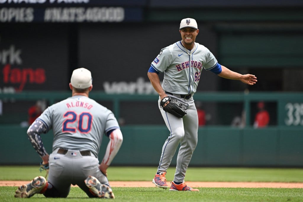 Mets starting pitcher Jose Quintana (62) looks back at first baseman Pete Alonso (20) after colliding with each other against the Washington Nationals