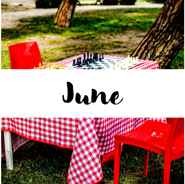 A table with two red chairs. On the table there's a checkered table cloth and two games of chess. In a white banner, the text reads "June". A table with two red chairs. On the table there's a checkered table cloth and two games of chess. In a white banner, the text reads "June".