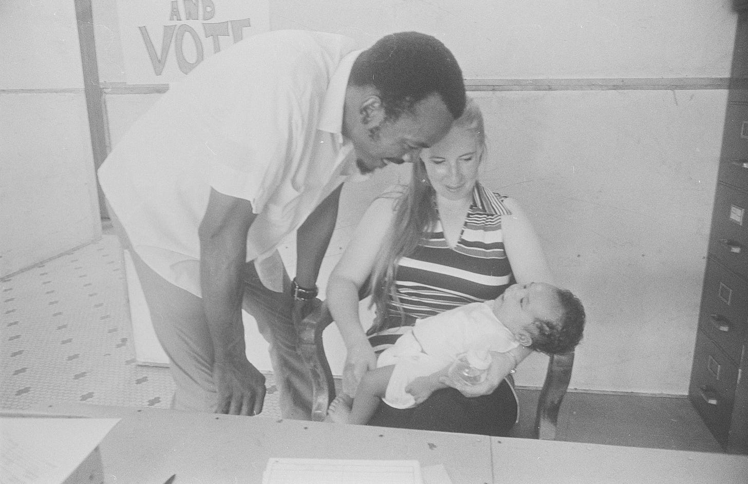 UFW organizers Dianna Lyons, Mack Lyons, and their son Rick Lyons at the union office, Haines City, Florida, 1972. Photo by John Kouns. © Tom and Ethel Bradley Center. UFW organizers Dianna Lyons, Mack Lyons, and their son Rick Lyons at the union office, Haines City, Florida, 1972. Photo by John Kouns. © Tom and Ethel Bradley Center.