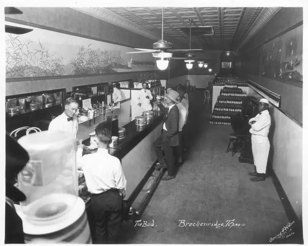 Flappers in their stylish dresses and men in sharp suits, enjoying a night out in defiance of the law, captured in a rare candid moment. Flappers in their stylish dresses and men in sharp suits, enjoying a night out in defiance of the law, captured in a rare candid moment.