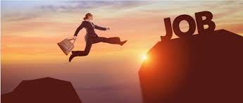 Woman jumping a gap between two rocks with a worksuit and bag.