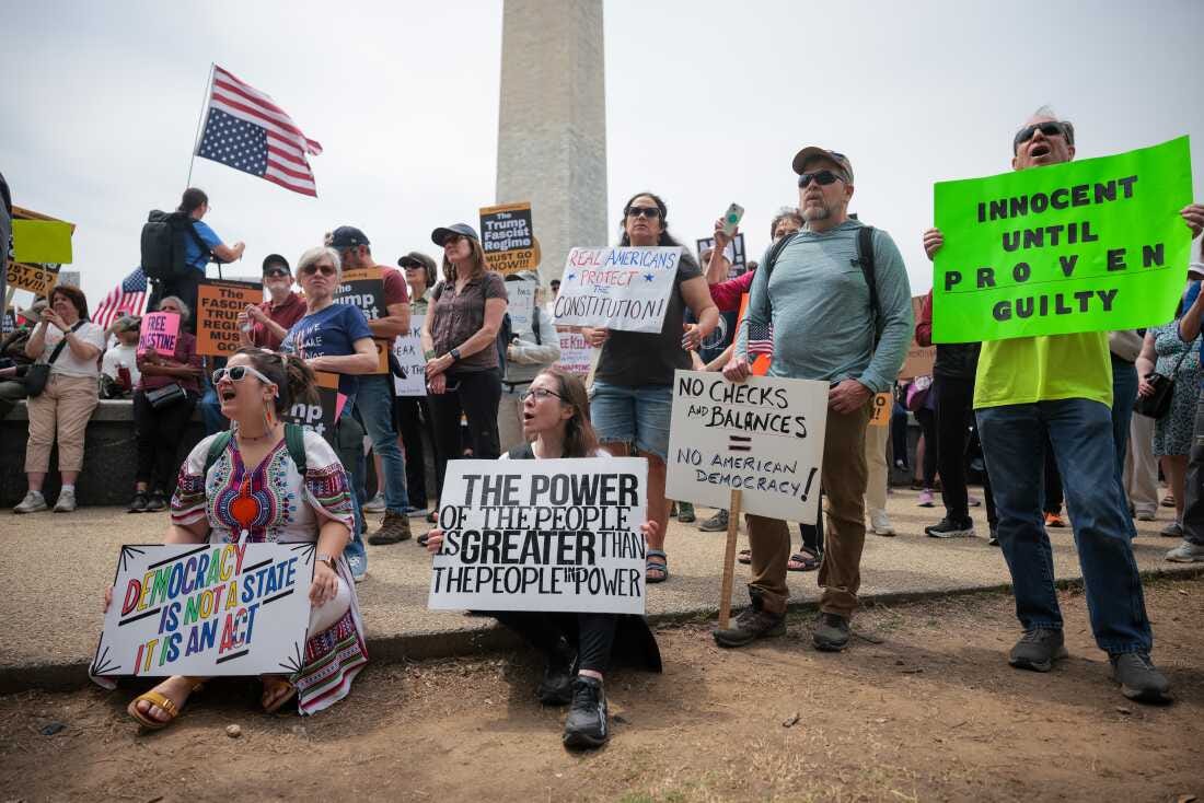 Heather Sarandos (C) from Baltimore holds up a sign while shouting during the Anti-Trump protest in Washington, D.C.. Heather Sarandos (C) from Baltimore holds up a sign while shouting during the Anti-Trump protest in Washington, D.C..