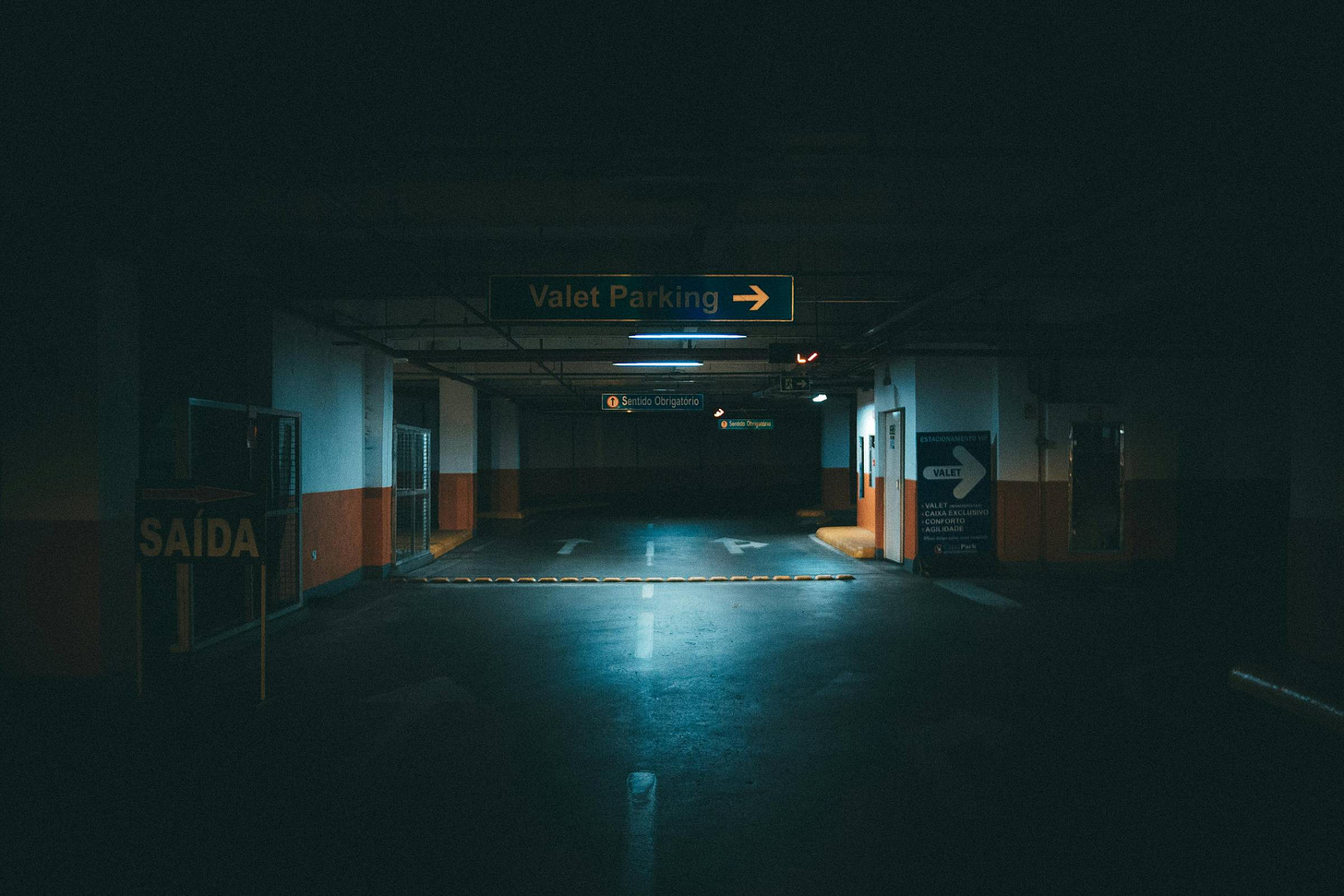 A dimly lit underground parking garage, symbolizing artificial light exposure and the lack of natural sunlight—one of the major disruptors of circadian rhythms.