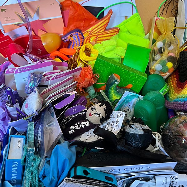 A close up of one of my trash altars, a repository of objects arranged by color as you encounter them, a mix of special things you don't know what to do with and just about anything else colorful.