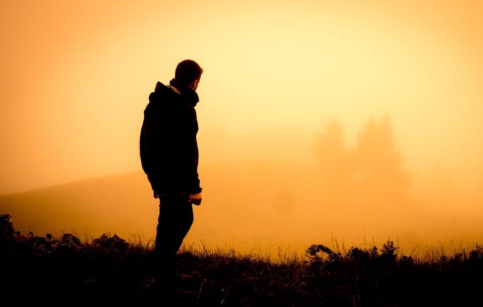 silhouette of man standing open field