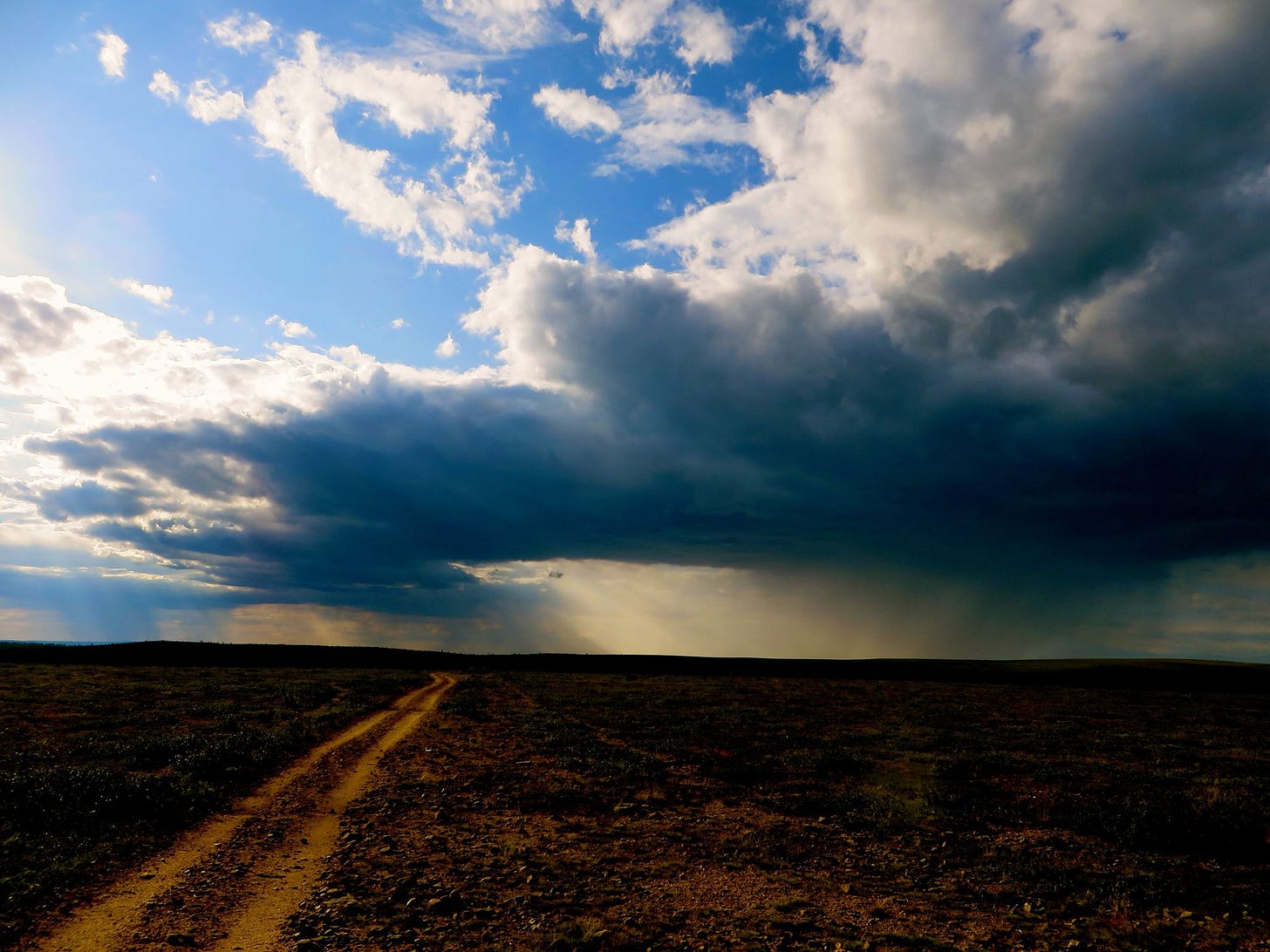 Storm clouds over a flat ridge.