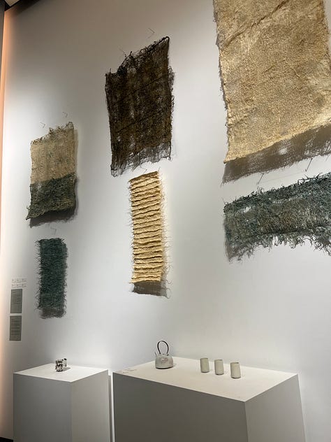 1. Zena Holloway -- Rootfull samples on the wall; 2. Nic Webb scorched wood lamp; 3. Scarlett Farrer sheepskin rug, with Studio Amos willow baskets.