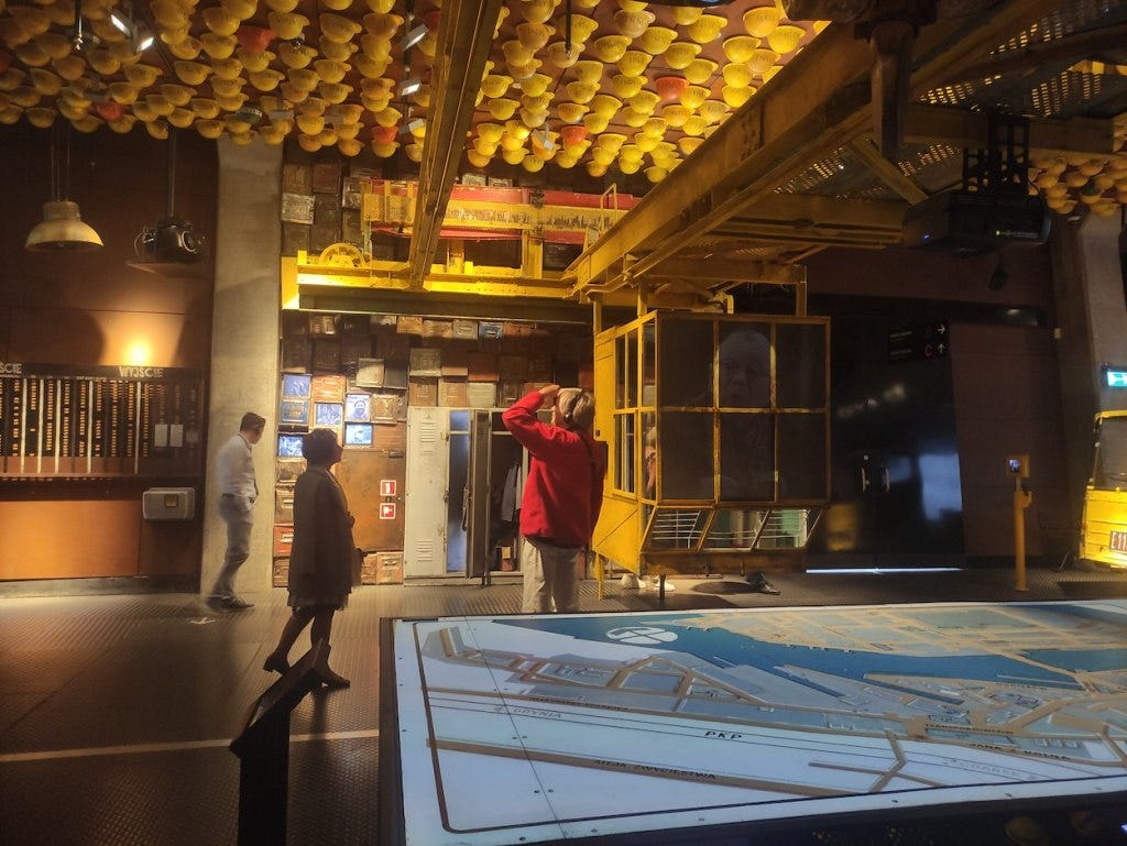 Hard hat are stuck to the ceiling in a room which has recreated the look of the Gdansk shipyards, with exhibits about the protests there