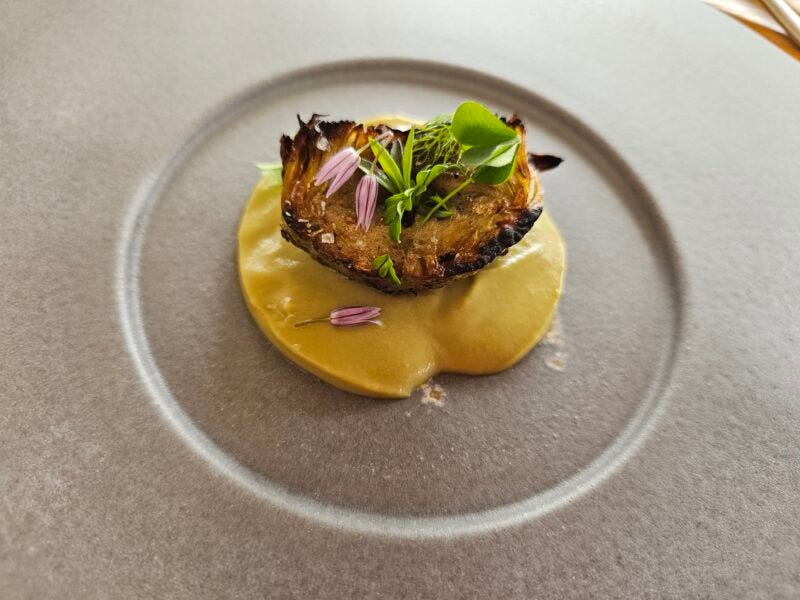 Grilled artichoke heart atop artichoke puree at Osmosi