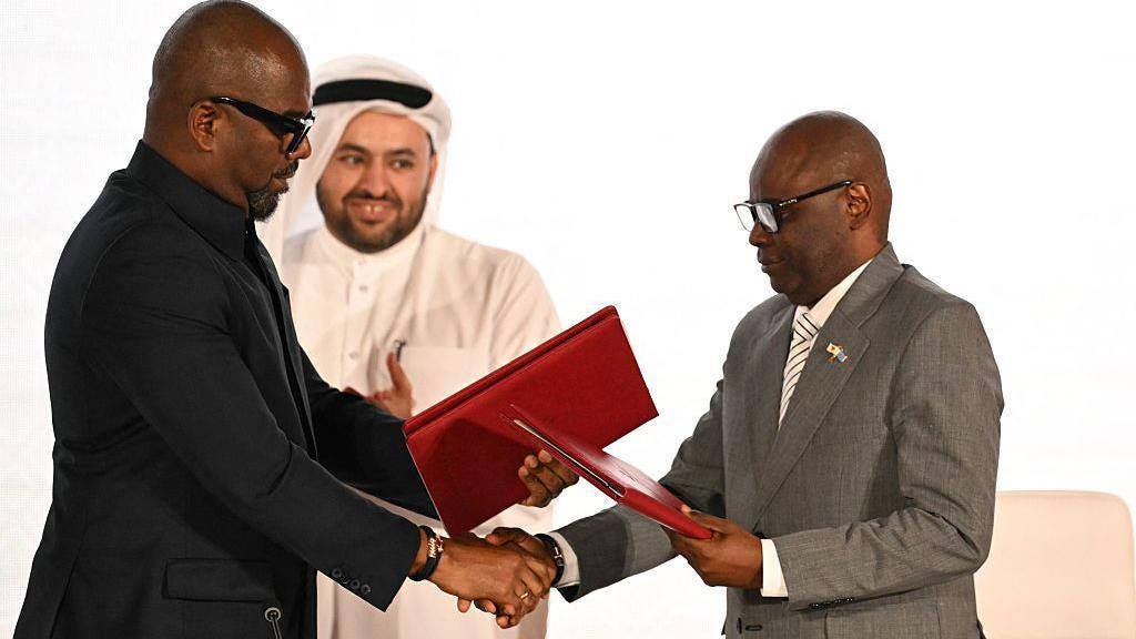 Qatar's chief negotiator Mohammed al-Khulaifi (C) observes as Sumbu Sita Mambu (L), a high representative of the head of state in the Democratic Republic of Congo (DRC) and and Rwanda-backed armed group M23 executive secretary Benjamin Mbonimpa (R) as they shake hands during the signing ceremony of the Comprehensive Peace Agreement between the DRC Government and the Congo River Alliance/March 23 Movement (AFC/M23) at the Sheraton Hotel in Doha, on 15 November. Qatar's chief negotiator Mohammed al-Khulaifi (C) observes as Sumbu Sita Mambu (L), a high representative of the head of state in the Democratic Republic of Congo (DRC) and and Rwanda-backed armed group M23 executive secretary Benjamin Mbonimpa (R) as they shake hands during the signing ceremony of the Comprehensive Peace Agreement between the DRC Government and the Congo River Alliance/March 23 Movement (AFC/M23) at the Sheraton Hotel in Doha, on 15 November.