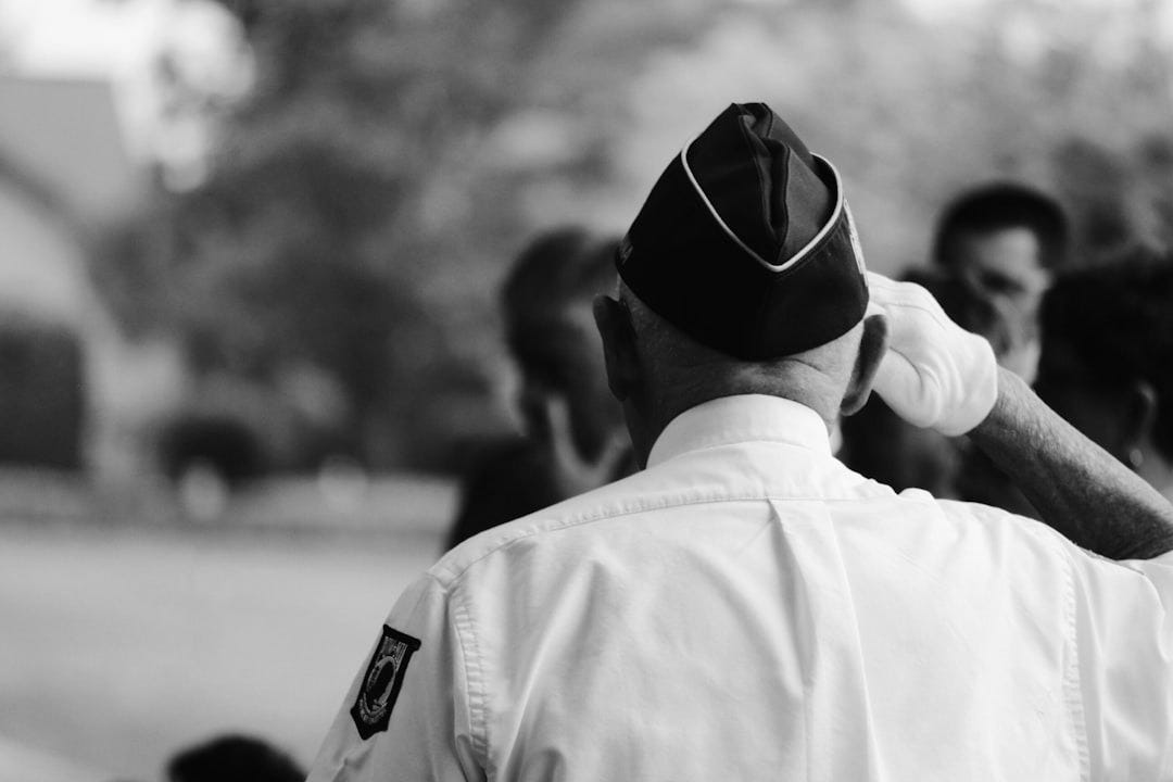 man wearing white uniform saluting man wearing white uniform saluting