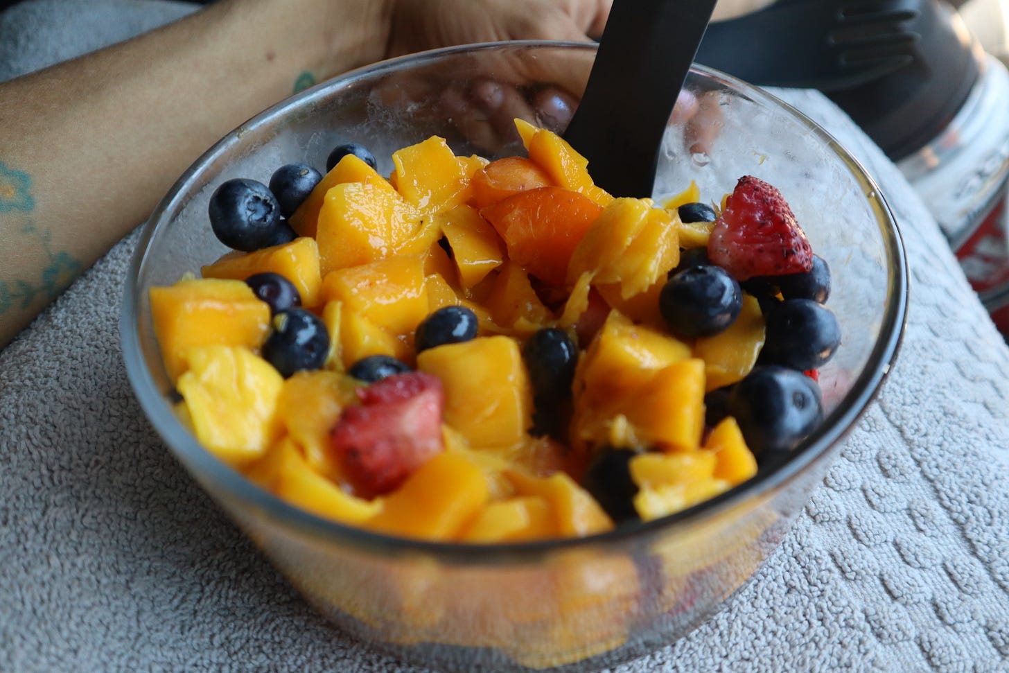 a bowl of fruit - mangoes, blueberries, strawberries and apricots