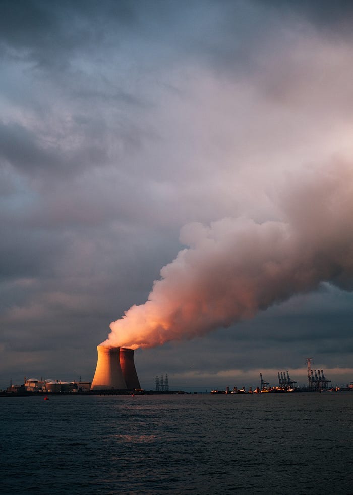 Nuclear smokestacks chugging steam into the air at sunset. Nuclear smokestacks chugging steam into the air at sunset.