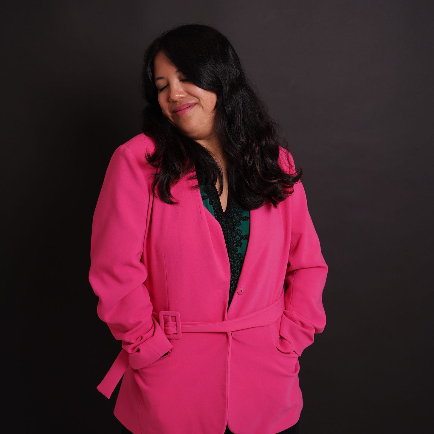 the author in a pink blazer and looking blissed out