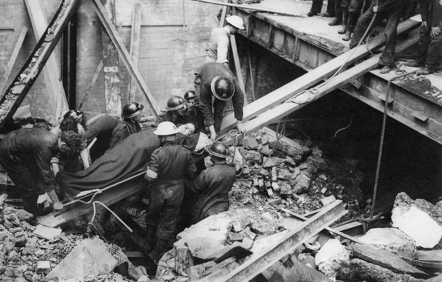 Mr. Harold Edward Reeves of Essex, miraculously rescued after 16 hours trapped in his car beneath 20 feet of wreckage in a bombed London garage on Sept. 18, 1940, offers a defiant smile. His resilience, despite incessant air raid warnings, embodied the spirit of Londoners during the Blitz. Mr. Harold Edward Reeves of Essex, miraculously rescued after 16 hours trapped in his car beneath 20 feet of wreckage in a bombed London garage on Sept. 18, 1940, offers a defiant smile. His resilience, despite incessant air raid warnings, embodied the spirit of Londoners during the Blitz.