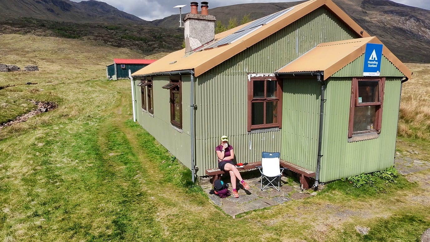A person sitting on a chair outside of a green house

AI-generated content may be incorrect.