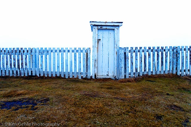 Photograph of a weathered doorway in a white picket fence by Ken Gehle. Photograph of a weathered doorway in a white picket fence by Ken Gehle.