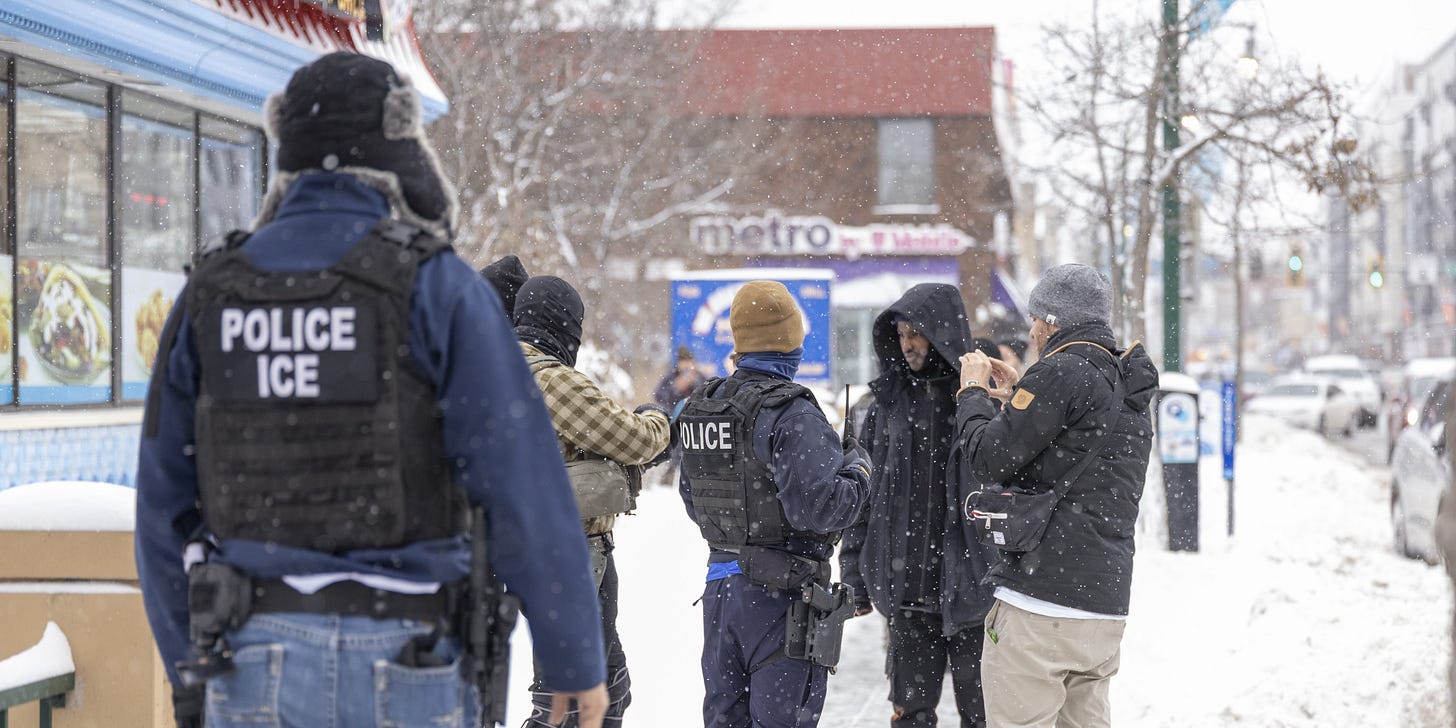 MINNESOTA, UNITED STATES - DECEMBER 10:  Immigrations, Customs, and Enforcement officers question a man's status on Lake Street near a Somali mall called the Karmel Mall in Minnesota, United States on December 10, 2025. They questioned him as activists and ICE agents confronted each other. (Photo by Christopher Juhn/Anadolu via Getty Images)