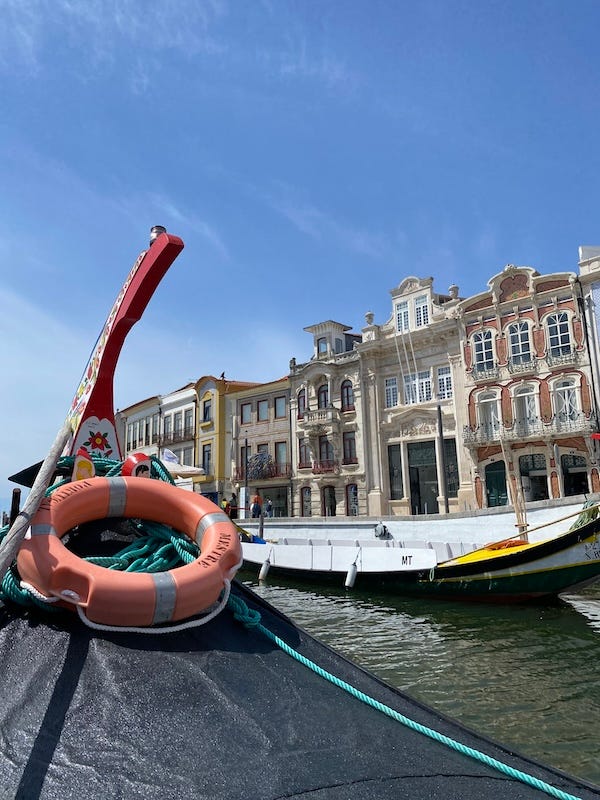 painted prow of canal boat with buildings of Aveiro in background painted prow of canal boat with buildings of Aveiro in background