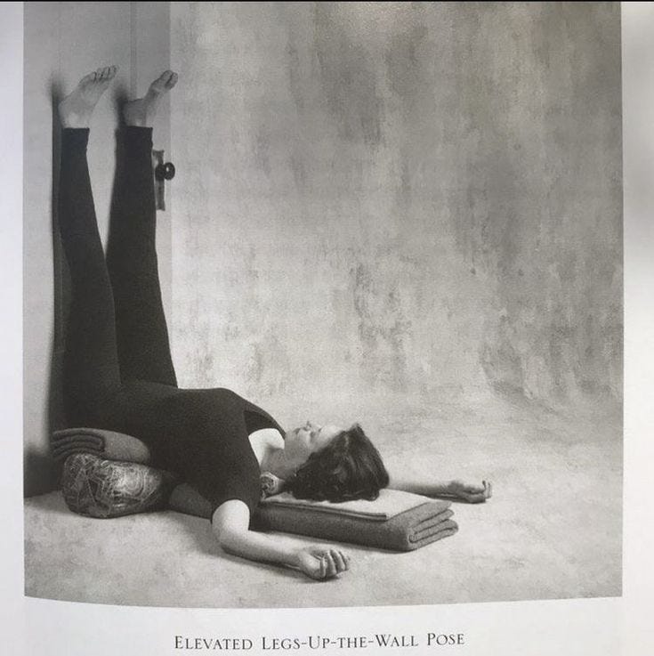This may contain: a black and white photo of a woman laying on the floor with her legs up