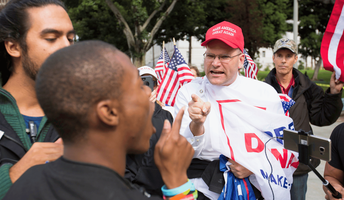 Los Angeles, California, January 18, 2017 — A heated exchange during an immigration protest. Shutterstock. Los Angeles, California, January 18, 2017 — A heated exchange during an immigration protest. Shutterstock.