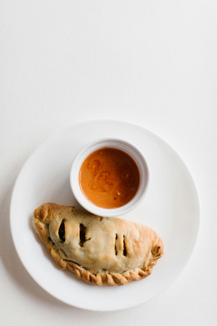Hand pie with dipping sauce. Fresh sage plant. Photos by Caroline Ross and Marina Yalanska via unsplash.