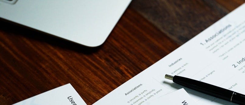 a pen sitting on top of a pile of papers
