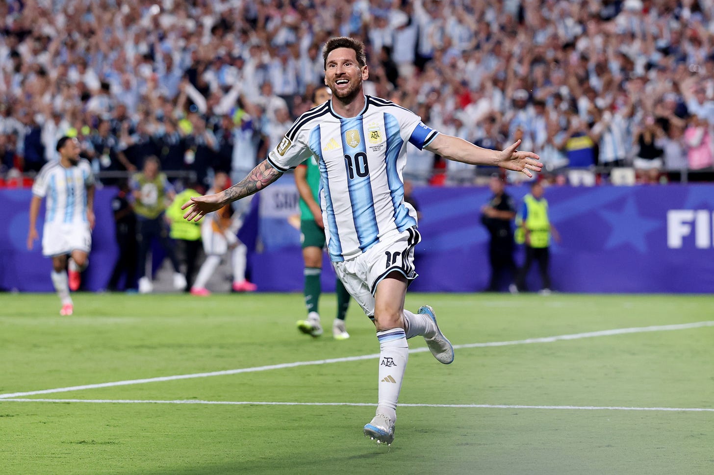 Lionel Messi smiles and celebrates with his arms out after his second goal against Algeria. Lionel Messi smiles and celebrates with his arms out after his second goal against Algeria.