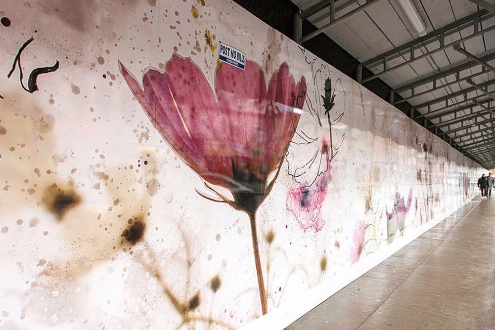 A wall with a painting of flowers

AI-generated content may be incorrect.