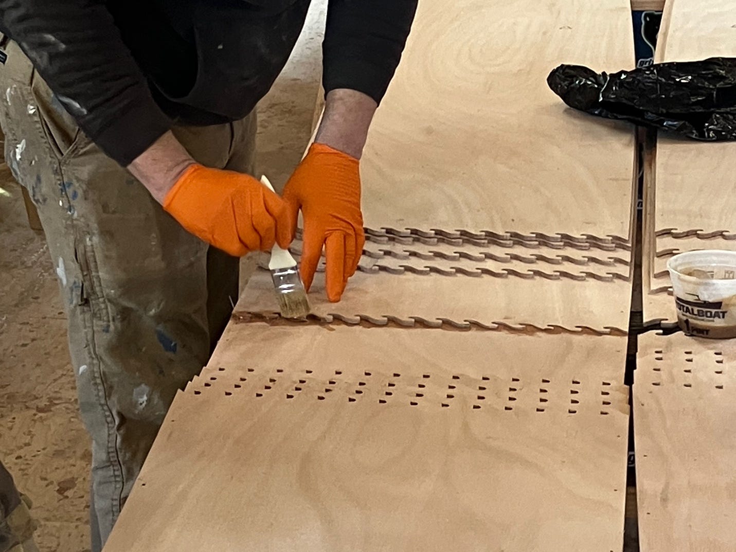 A person painting a wood surface

AI-generated content may be incorrect.