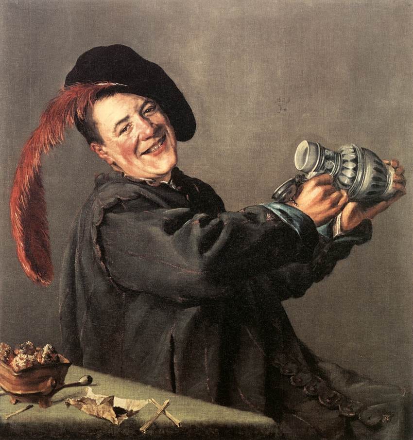 Grinning man raising glass