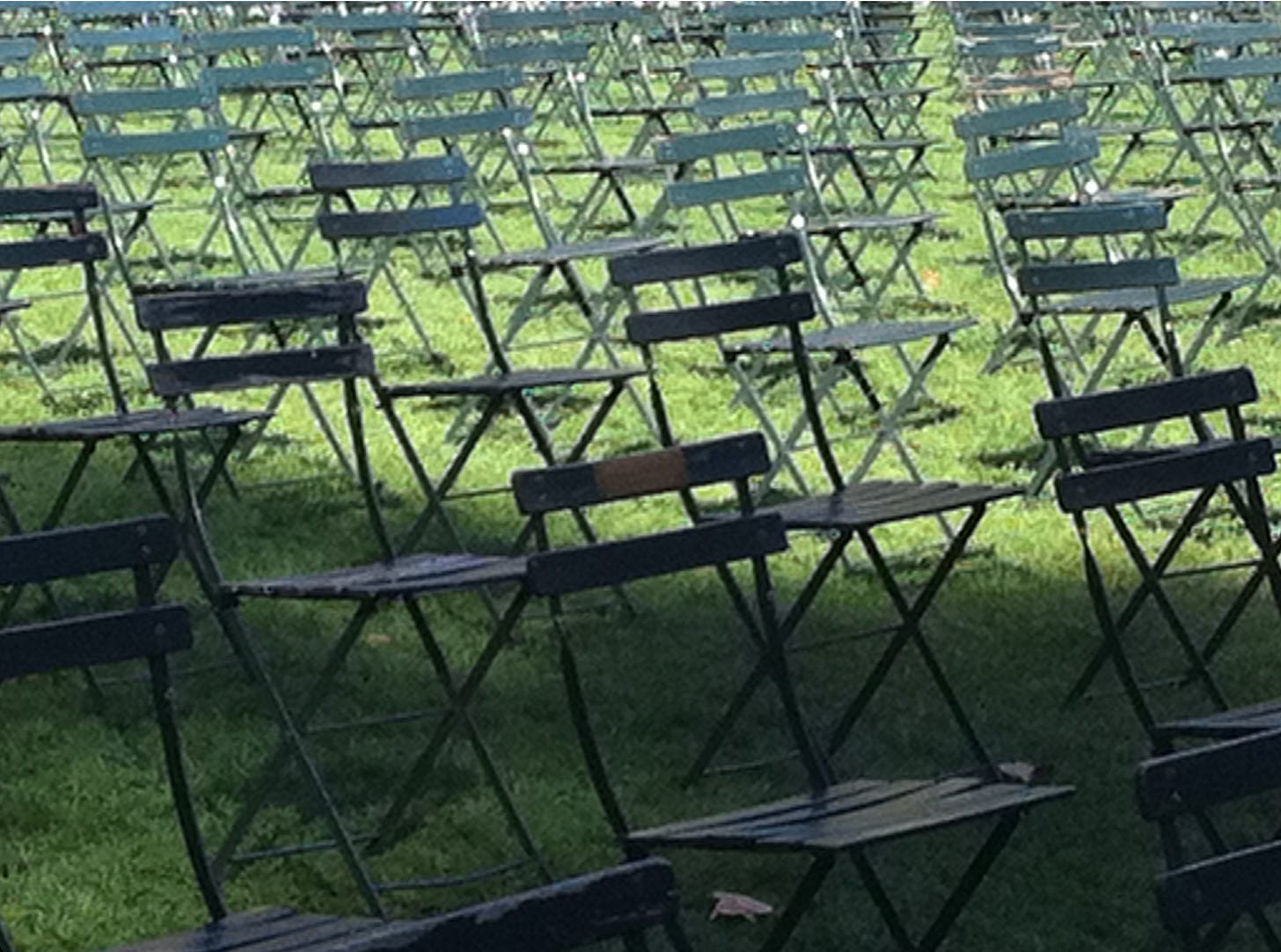 Memorial chair bearing a memorial plaque honoring David Tengelin, photographed by Patric Tengelin in Bryant Park during the 2002 anniversary, with hundreds of chairs arranged behind it to represent the 2,753 lives lost at the World Trade Center.