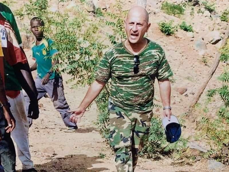 A person in camouflage shirt and cap walking on dirt

AI-generated content may be incorrect.