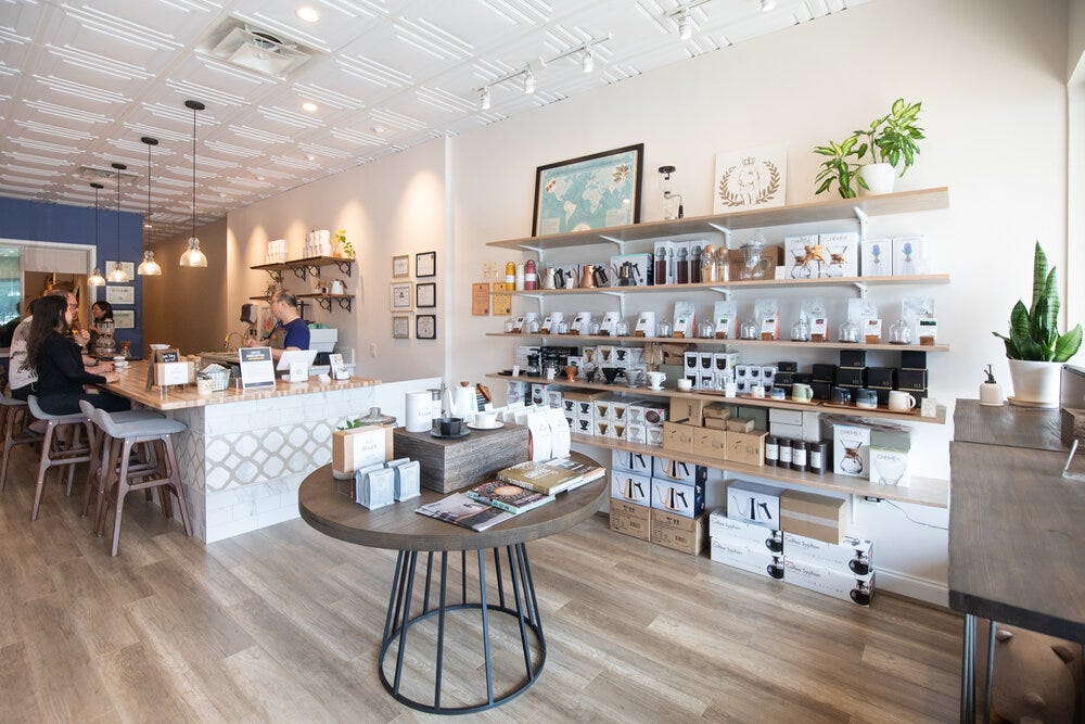 Interior at Belux Coffee Roasters. The shop contains various coffee equipment for sale as well as about a dozen of different coffees.
