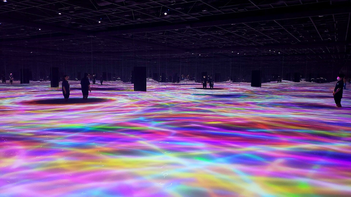 Visitors walk across a glowing digital water floor at teamLab Planets in Tokyo. Image: Sasa0403 via Wikimedia Commons Visitors walk across a glowing digital water floor at teamLab Planets in Tokyo. Image: Sasa0403 via Wikimedia Commons