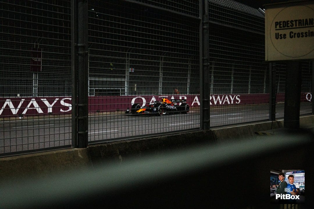 A race car is driving on the track A race car is driving on the track