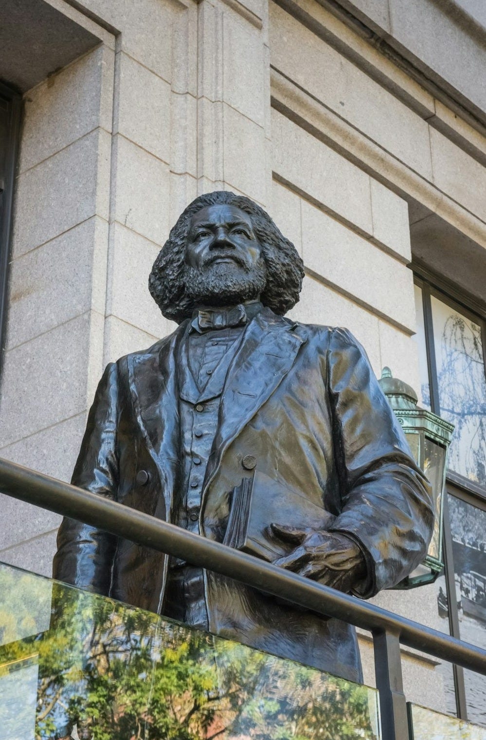 a statue of a man with a book in his hand