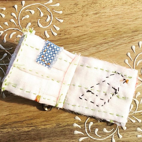 Tiny books and bunting, hand stitched from colorful vintage baby clothes.