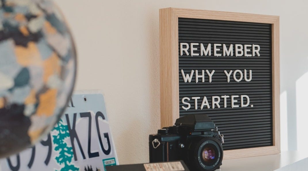shallow focus photo of black SLR camera on white wooden shelf shallow focus photo of black SLR camera on white wooden shelf