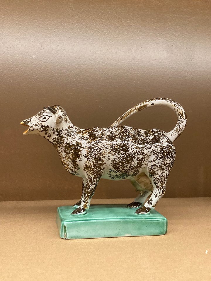 Four images of ceramic cow creamers, made late 18th centruy to early 19th century, and image of shelves holding several jugs
