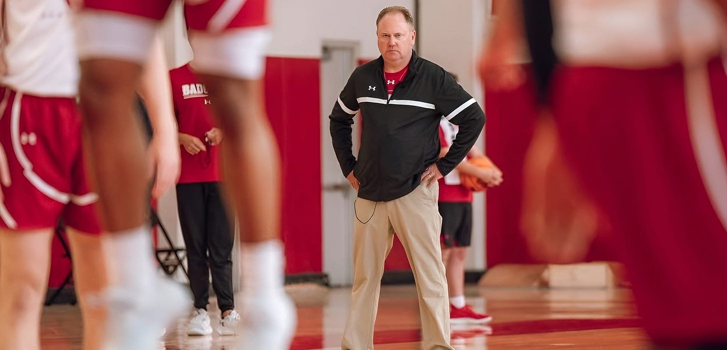 Greg Gard stands on the court observing Wisconsin men's basketball players practice at Nicholas-Johnson Pavilion.