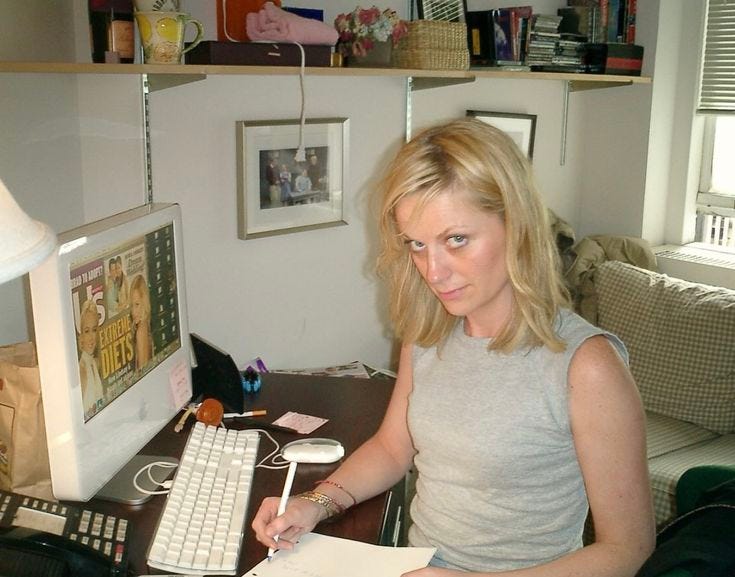 This may contain: a woman sitting at a desk in front of a computer with a keyboard and mouse This may contain: a woman sitting at a desk in front of a computer with a keyboard and mouse